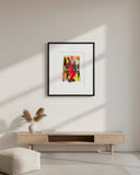Framed abstract artwork with a colorful depiction of a dancer on a gray wall.