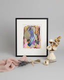 Framed abstract art piece with colorful shapes on a white background