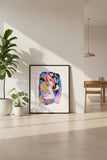 Framed abstract artwork with vibrant colors on a white wall